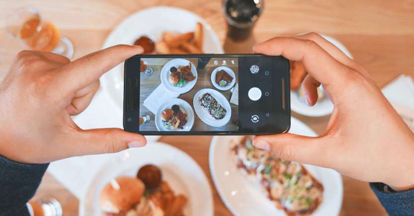 Person taking photo of food