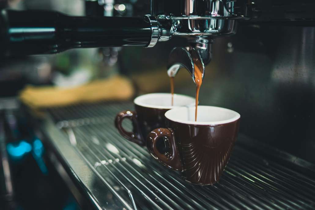 An espresso machine pulls a shot of espresso on national espresso day