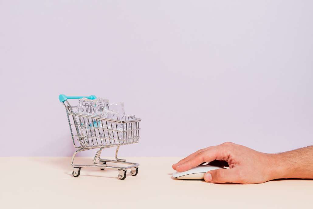 CPG Marketing Terminology - Hand Clicking Mouse next to Mini Shopping Cart